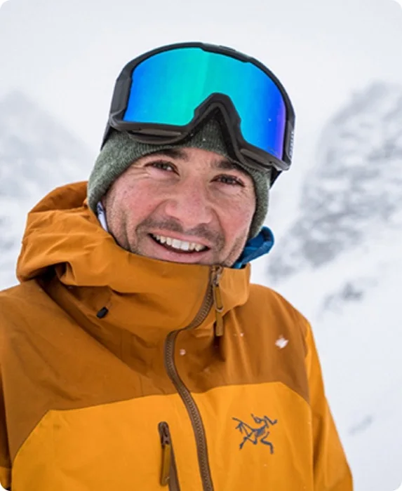Ross Berg in an orange jacket and goggles